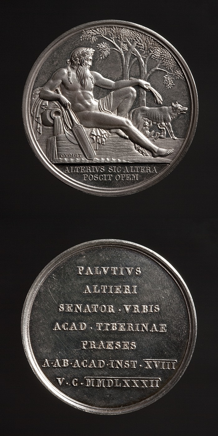 Medalje forside: Tiberflodens Gud og Romulus og Remus som dier ulvinden. Medalje bagside: Indskrift