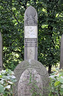 Adam Müller, grav på Assistens Kirkegård, København. Udsmykket med Thorvaldsens Malerkunstens genius